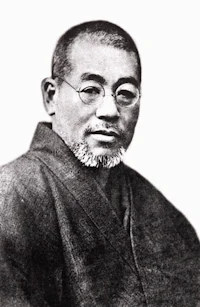 a black and white photo of a man with glasses and a beard